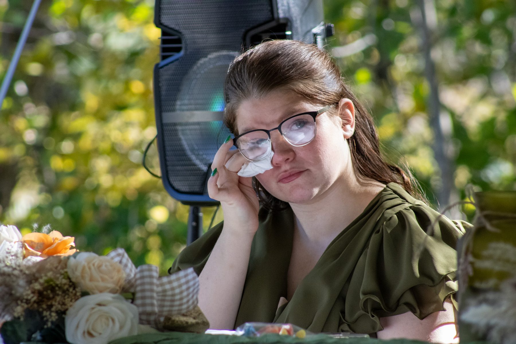 A bridesmaid wiping away happy tears during the ceremony