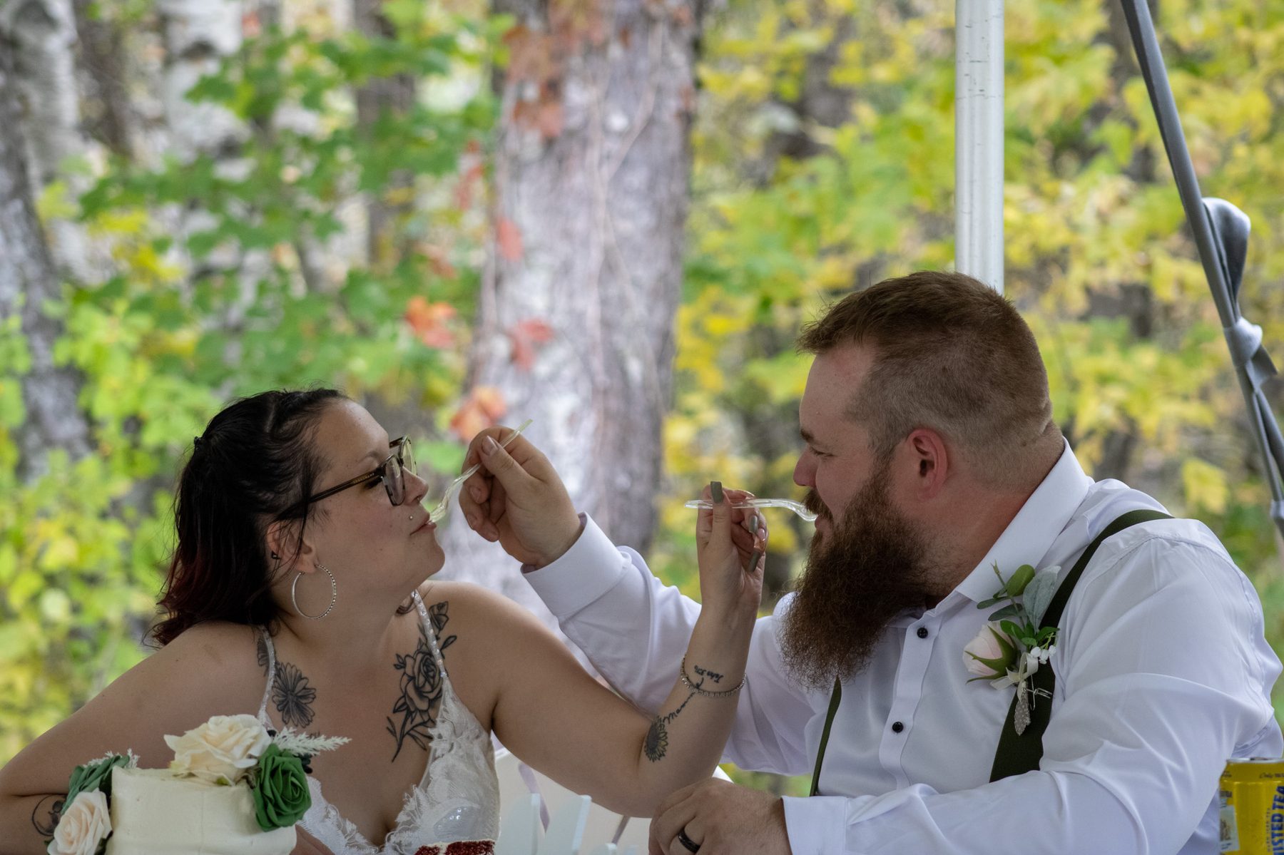 Bride and groom feeding each other wedding cake