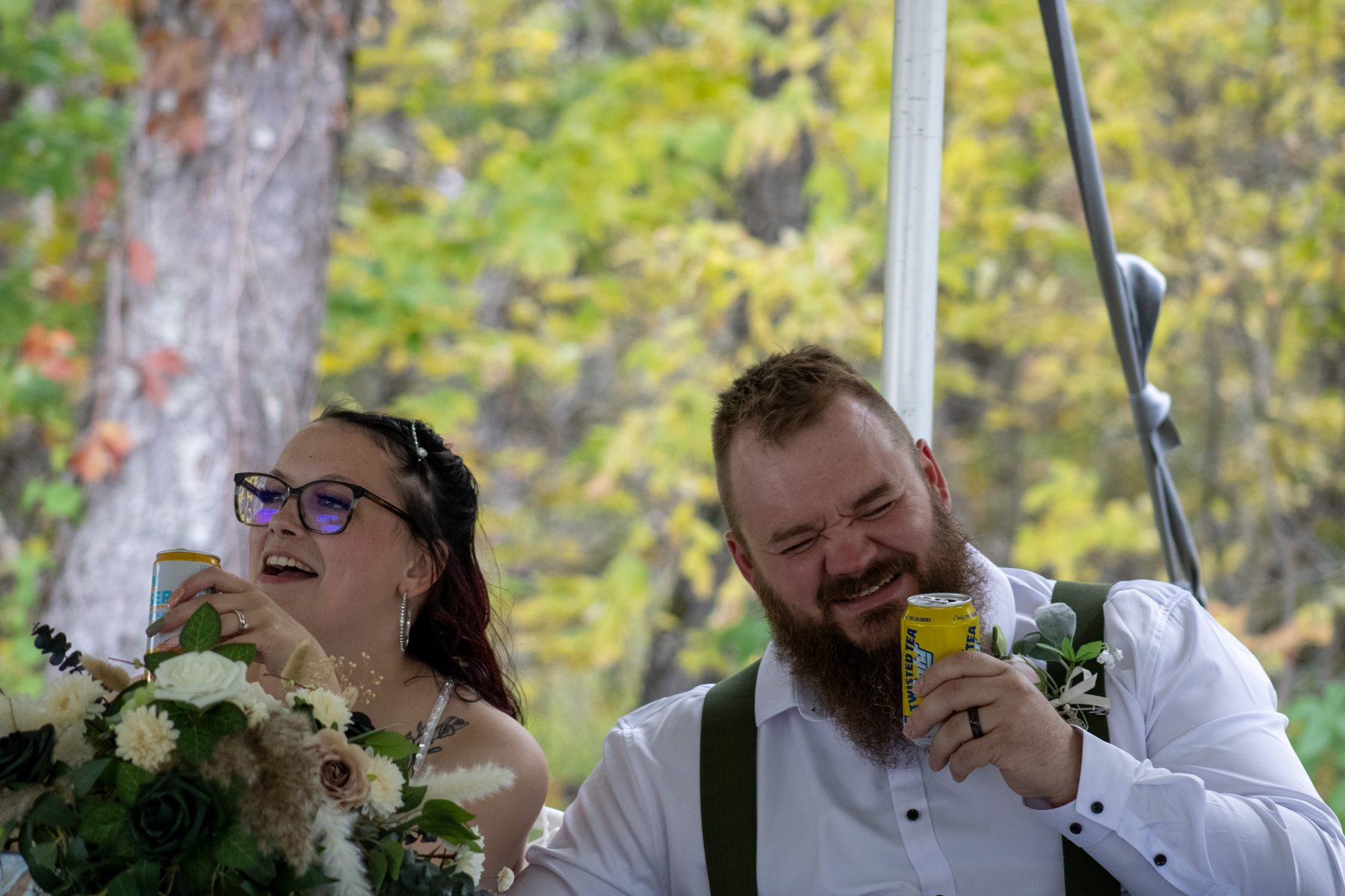 Bride and groom laughing together at their reception