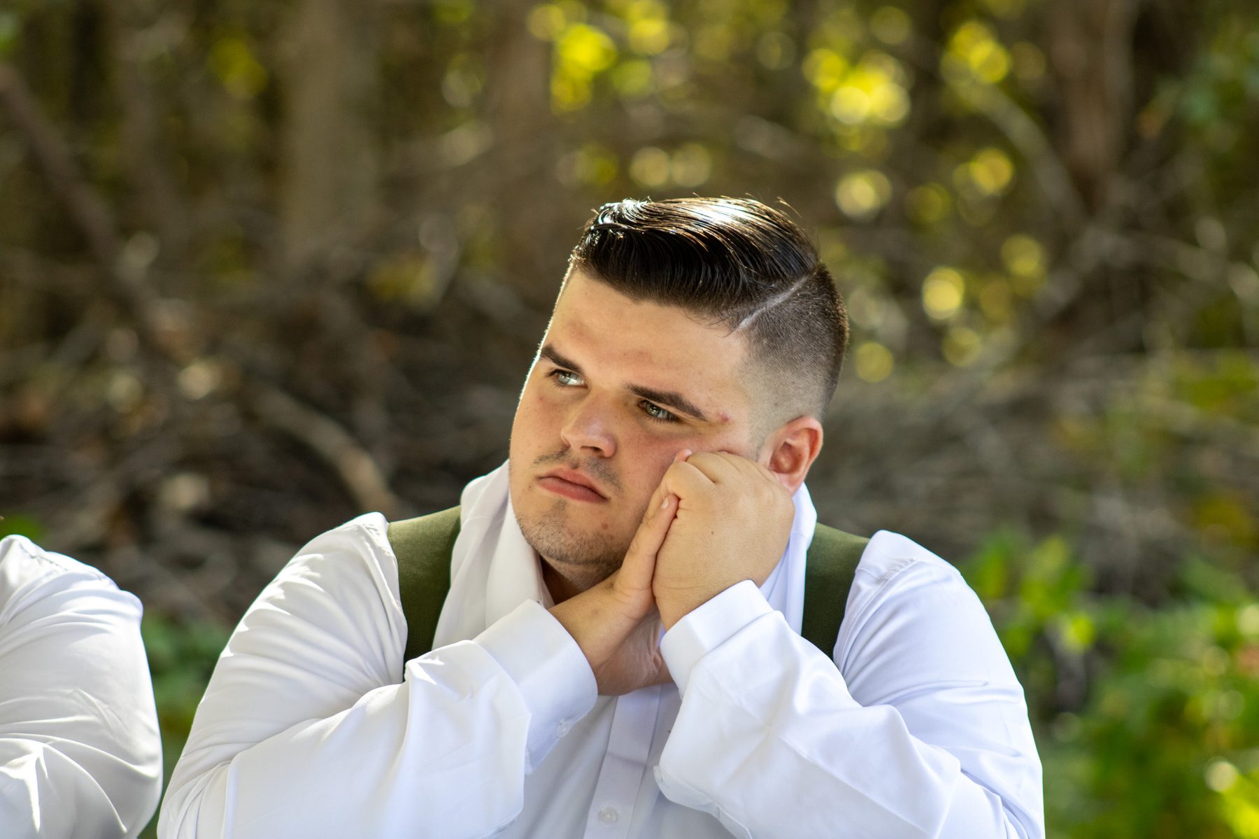 Groomsman portrait in dappled forest light